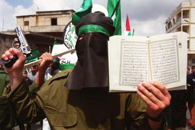 A Muslim 

holding the Koran in his left hand and in the right hand, he holds a gun. Perfect 

combination!!!