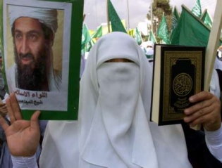 A 

Muslim holding the Koran in his left hand and in the right hand, he holds a gun. 

Perfect combination!!!