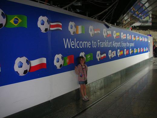 Isabelle at the airport in front of the Fifa's flags