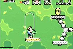 Super Mario World: Mario is on Yoshi while waiting to nab the next YCoin.