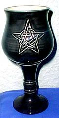 A chalice with a pentacle on it