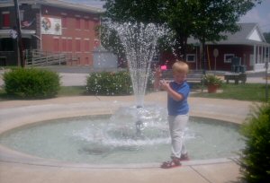 This is my nephew Jayden Jaroth standing by our fancy fountain in town square. Whoo- Hoo!