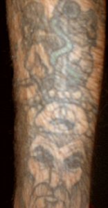 This is the cross & serpent above the wizards head with representations of Man and Woman on either side.