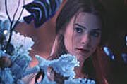 Romeo and Juliet first spy each other through a fish tank.