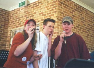Katie, Paul and Eamon singing. Everyone laugh at Paul and Eamon.