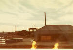 Early morning scene with flaming half barrels of laterine duty