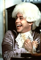 A cheerfully bewigged Tom Hulce.