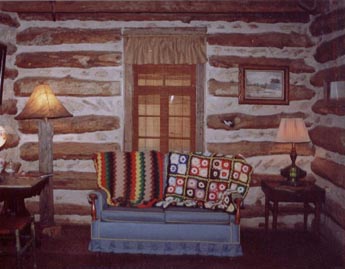 Comfort is found in the log cabin with it antique couch and chair placed to enjoy the TV/VCR. Many replicas found on the property and in the walls of the house are now displayed in shadow boxes and other locations in the cabin. 