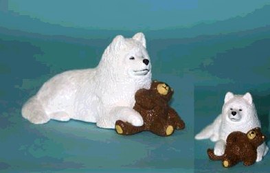 Samoyed Holding his Teddy Bear