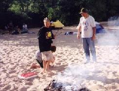 Image of scouts cooking and setting up camp on a sand bar
