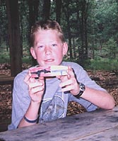 Image of Scout with Woodcarving work
