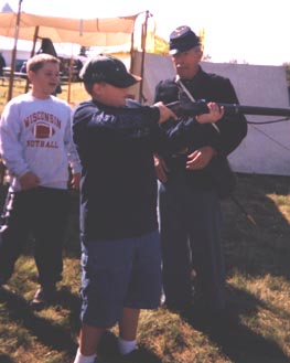 Image of Two Scouts learning about a musket