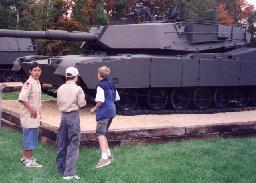 Image of Scouts looking at an Abrams tank