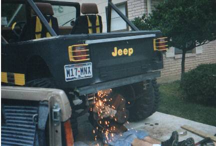Mike works on his own jeep