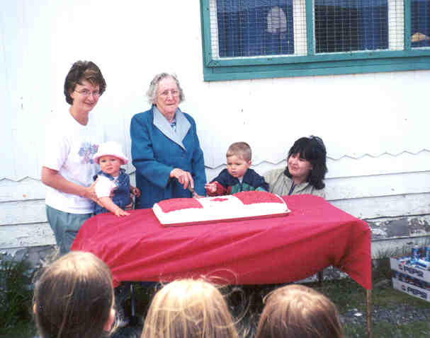 Amber Culleton, Kelly Culleton, Mrs. Margaret Spurvey, Cody Traverse and Tina Duke cutting the cake
