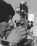 Gerald surveys landmarks using the theodolite.