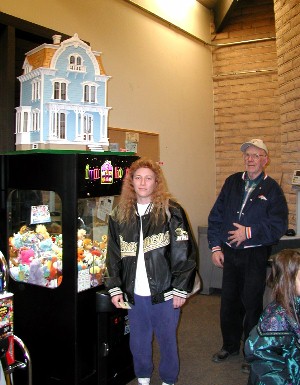Mrs. Atencio standing beside the Doll House