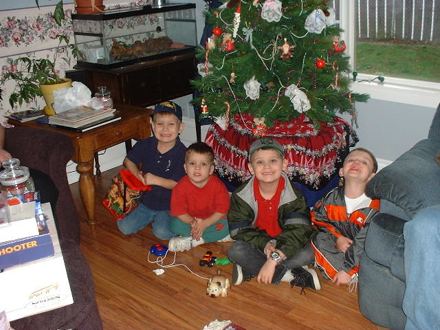 Boys around tree 12-25-01