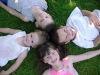 Stock Photo Description: Three boys and a girl; happy children in a friendship circle. 