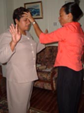 Pastor Allison Praying for Pauline Clarke Funds Administrator