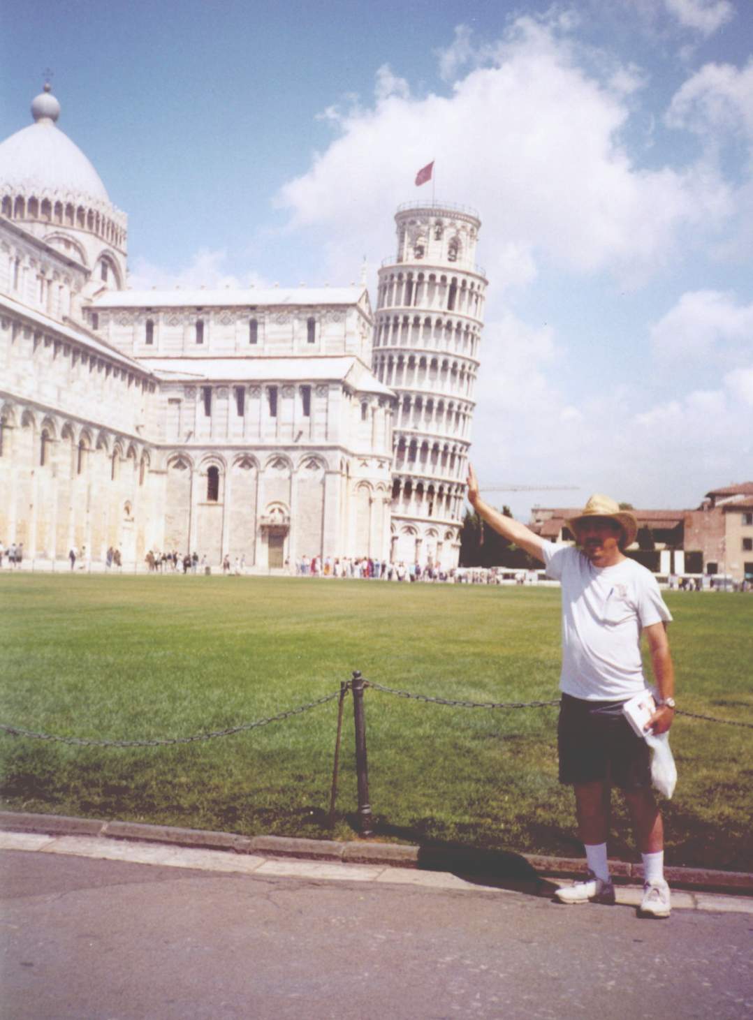 Gregg in Pisa, holding up the Leaning Tower
