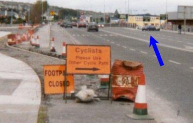 Sign directing cyclists to cycle against the normal flow of traffic.  Headford Road 