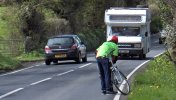 [ Gary having to check something on his bike by the side of a busy, narrow road ]