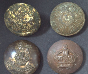 The group of four are: Top left - a livery button, top right - another Scots Guards.  Bottpm left - Royal Army Pay Corps, bottom right and Governmental livery or a general issue button for a non military uniform maybe Staff to Queen Elizabeth, the Queen Mother.
 