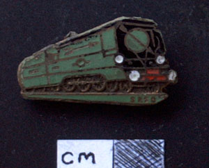 Golden Arrow badge 1950s.
Hauled at first by Lord Nelson class steam locomotives, the Southern Railway's all-Pullman Golden Arrow train started off as the `White Pullman' train which ran from London's Victoria Station to Dover from 1924. 
It became the Golden Arrow in May, 1929, with passengers enjoying special customs handling and their very own ship, the 'Canterbury', for the journey across the Channel before boarding another train in France for the final leg of the trip to Paris Leaving London at 11 am; Golden Arrow passengers would arrive in Paris at 5.35 pm the same day. 
The Golden Arrow ceased during the Second World War but was restarted in 1946 when Bulleid Pacific steam locomotives started hauling the trains. The peak of the Golden Arrow was in 1951 - the year of London's Festival of Britain - when the impressive Britannia class steam locomotives started to haul the service and the train was given seven specially built Pullman carriages. 
But from the mid-1950s, the service began a steady and decline: its luxurious Pullman coaches were slowly replaced by ordinary carriages. The service was electrified in June, 1961, and ended in September, 1972. 