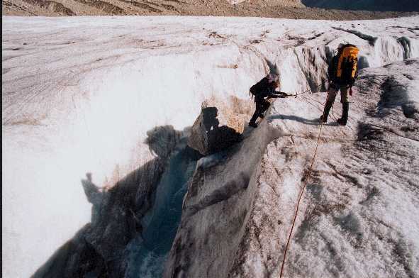 Rob climbing down into river