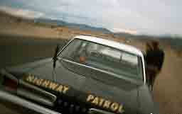 Police officer issuing a speeding ticket to Dave