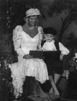 Tyler and Nana reading in turn of the century clothes.