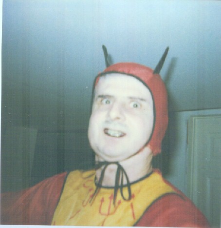 Devil me shown from chest up, wearing black eyebrow liner and black lipstick!