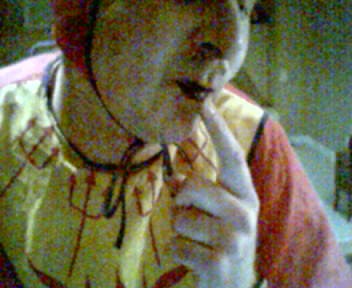 Me in my devil outfit, pointing at my black lips
