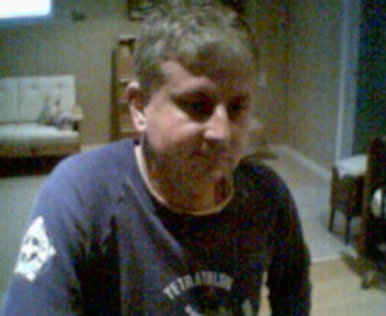 Me in navyblue 'Tetrathlon' sweatsuit, sitting and staring downward