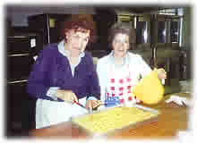 This two ladies are making KREATOPITES GREEK STUFFED MEAT TRIANGLES