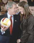 George W. Bush was presented with a volleyball signed by the USC Women's Volleyball Team