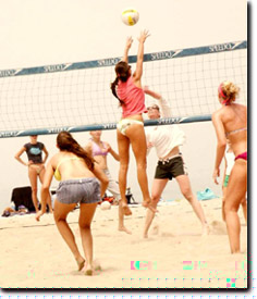 Lauren blocking in a beach volleyball tournament