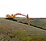 Excavator trenching for utilitiy lines a half mile from Poland Hill. June, 2001.