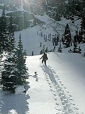 Stacy Bender slogging steadfastly beneath the Northwest Face of Thatchtop, 1 March, 2003.