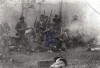 Civil War re-enactor battle sceen, black and white picture with blue uniformed soldier in center.