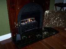 This is the gas fireplace and the antique fire guard for the safety of our guests.