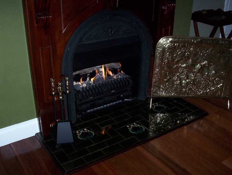 This is the gas fireplace and the antique fire guard for the safety of our guests.