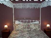 This magnificent four-post queen size antique bed will enchant any of our guests.