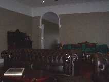 This is the main lounge and dining area. Chesterfields and an antique dining table.
