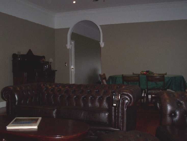 This is the main lounge and dining area. Chesterfields and an antique dining table.