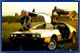 John Delorean leaning on a Delorean