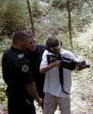 SRT officers tesching a student how to use the sage gun