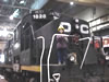 In front of a black train.