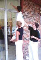 Chad Aurell washes windows with the help of Brandon Dubose and James Selby